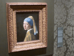 Painting `Girl with a Pearl Earring` by Johannes Vermeer, with explanation, at Room 15 at the Second Floor of the Mauritshuis museum