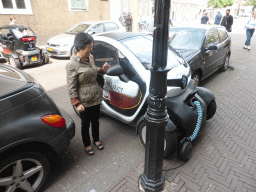 thehague_4_115 - 317 kb - 1024x768 - Miaomiao`s mother with a small electric car at the Heulstraat street Miaomiao`s mother with a small electric car at the Heulstraat street