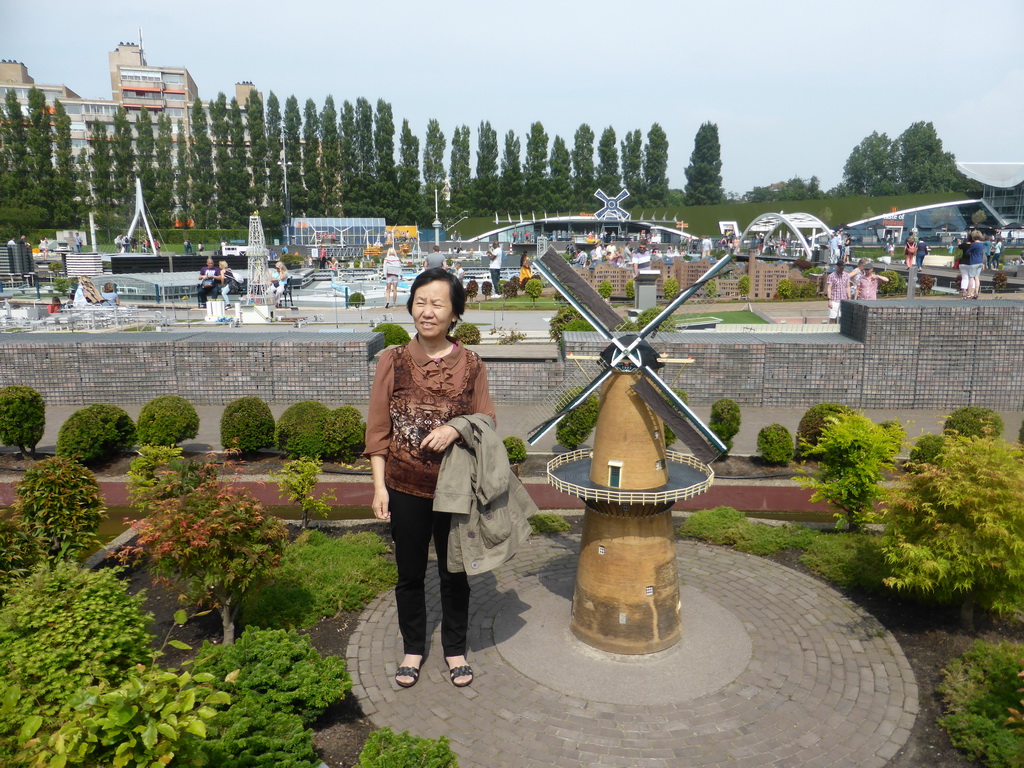 Miaomiao`s mother with a scale model of the windmill `De Nieuwe Palmboom` of Schiedam at the Madurodam miniature park