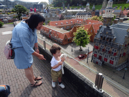 Miaomiao and Max in front of scale models of buildings at the Madurodam miniature park