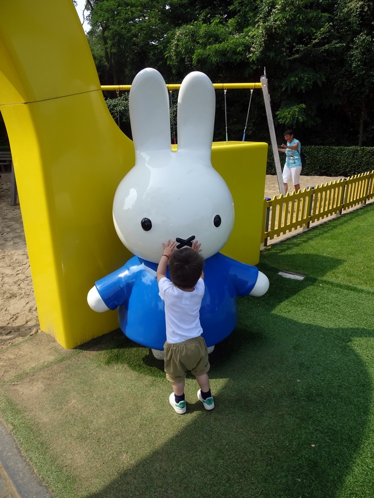 Max with a Nijntje statue in front of the playground at the Madurodam miniature park