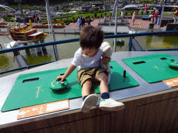Max playing with the wind turbines at the Madurodam miniature park