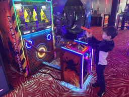 Max playing a shooting game at the Sir Winston Fun & Games arcade