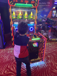 Max playing a shooting game at the Sir Winston Fun & Games arcade