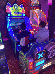 Miaomiao and Max playing a shooting game at the Sir Winston Fun & Games arcade