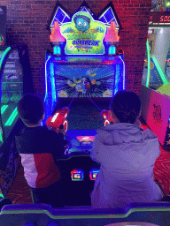 Miaomiao and Max playing a shooting game at the Sir Winston Fun & Games arcade