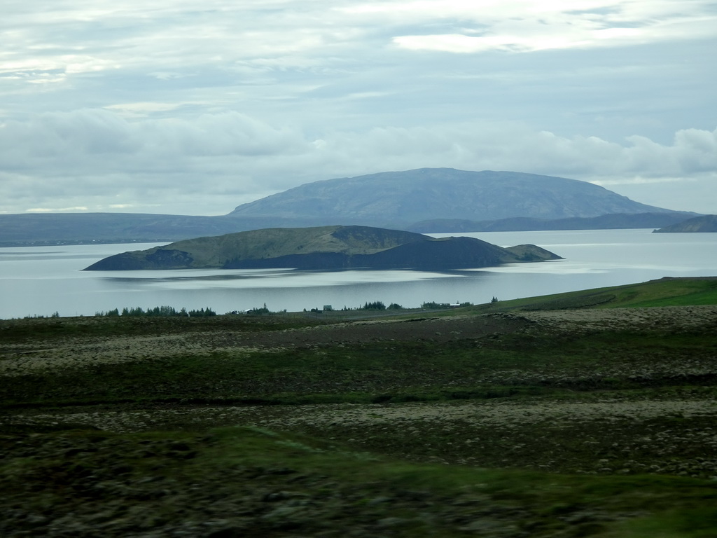 The west side of the Þingvallavatn lake with the Sandey island, viewed from the rental car on the Þingvallavegur road