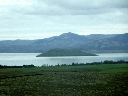 The west side of the Þingvallavatn lake with the Nesjaey island, viewed from the rental car on the Þingvallavegur road