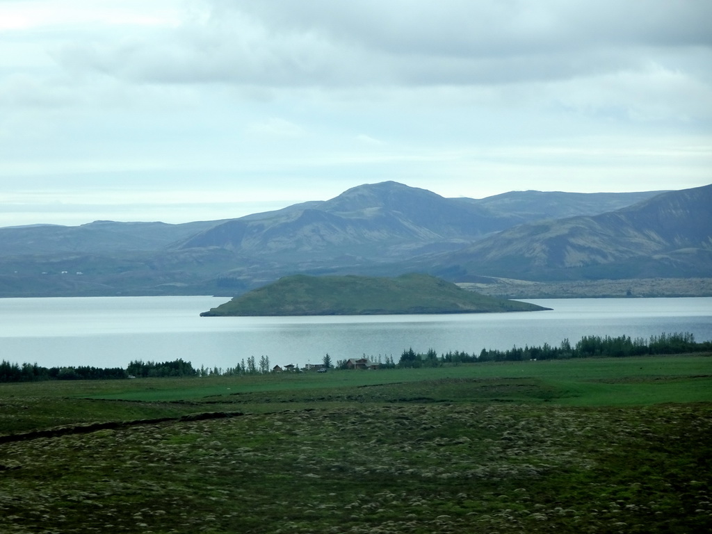 The west side of the Þingvallavatn lake with the Nesjaey island, viewed from the rental car on the Þingvallavegur road