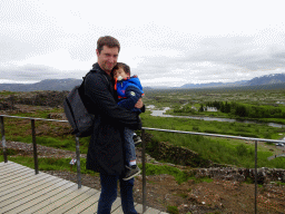Tim and Max at the Hakið Viewing Point, with a view on the Þingvellir National Park with the Þingvellir Church and houses