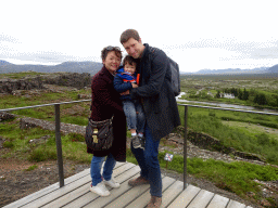 Tim, Miaomiao and Max at the Hakið Viewing Point, with a view on the Þingvellir National Park with the Þingvellir Church and houses