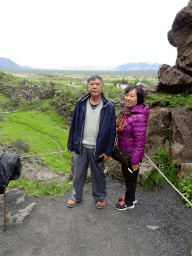 Miaomiao`s parents at the path through the Almannagjá Gorge, with a view on the Þingvellir National Park with the Þingvellir Church and houses