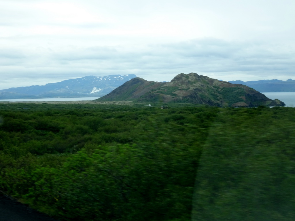 The northeast side of the Þingvallavatn lake, smoke from a power plant and mountains, viewed from the rental car on the Þingvallavegur road