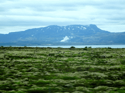 The northeast side of the Þingvallavatn lake, smoke from a power plant and mountains, viewed from the rental car on the Þingvallavegur road