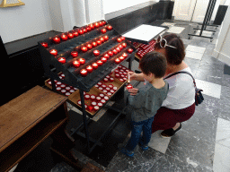 Miaomiao and Max lighting candles at the Sint-Michaëlskerk church