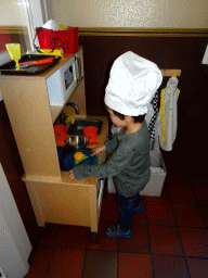 Max playing in the toy kitchen at the Pannekoekenbakker restaurant