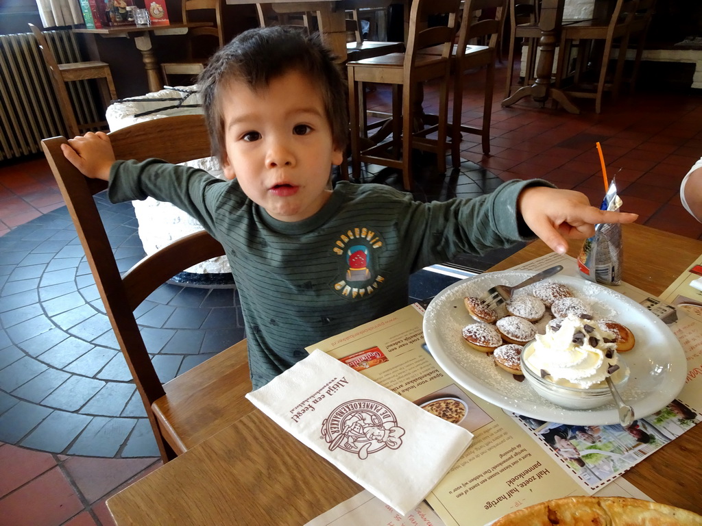 Max eating poffertjes at the Pannekoekenbakker restaurant