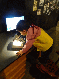 Max looking through a microscope at the `Jouw Brabant, mijn Brabant - een landschap vol herinneringen` exhibition at the first floor of the Natuurmuseum Brabant