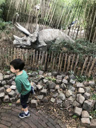 Max with a Triceratops statue at the Dierenpark De Oliemeulen zoo