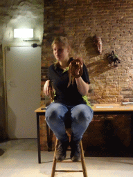 Zookeeper with a snake during the snake and spider demonstration at the Upper Floor of the main building of the Dierenpark De Oliemeulen zoo