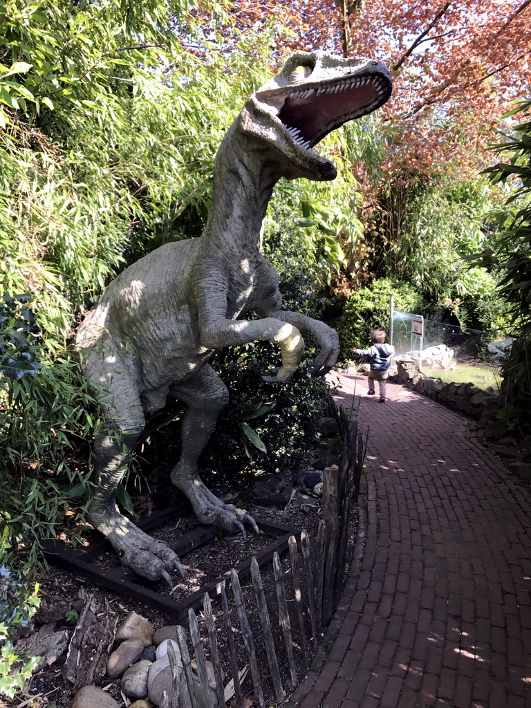 Max with a Dinosaur statue at the Dierenpark De Oliemeulen zoo