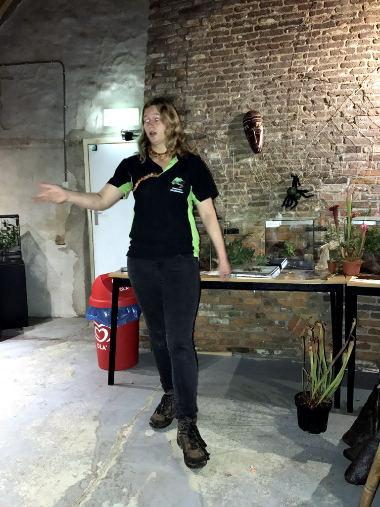 Zookeeper with a snake during the snake and spider demonstration at the Upper Floor of the main building of the Dierenpark De Oliemeulen zoo