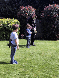 Zookeeper and children with a Barn Owl during the Birds of Prey Show at the Dierenpark De Oliemeulen zoo