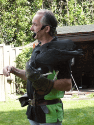 Zookeeper and Black Vulture during the Birds of Prey Show at the Dierenpark De Oliemeulen zoo