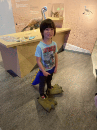 Max with dinosaur tail and feet at the `Vreemde vogels, die dino`s` exhibition at the second floor of the Natuurmuseum Brabant