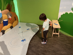 Max at the fishing game at the `Kikker is hier!` exhibition at the second floor of the Natuurmuseum Brabant