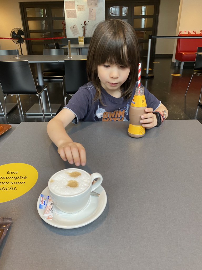 Max with a Chocomel at the Museumcafé at the ground floor of the Natuurmuseum Brabant