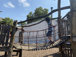 Max on a rope bridge at the playground at the Dierenpark De Oliemeulen zoo