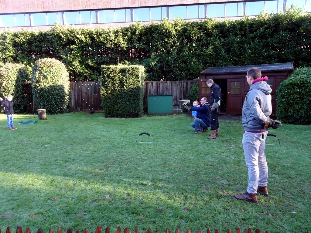 Zookeepers, spectators and a Northern White-faced Owl during the Birds of Prey Show at the Dierenpark De Oliemeulen zoo