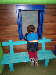 Max at the window of the home of Kikker at the `Kikker is hier!` exhibition at the second floor of the Natuurmuseum Brabant