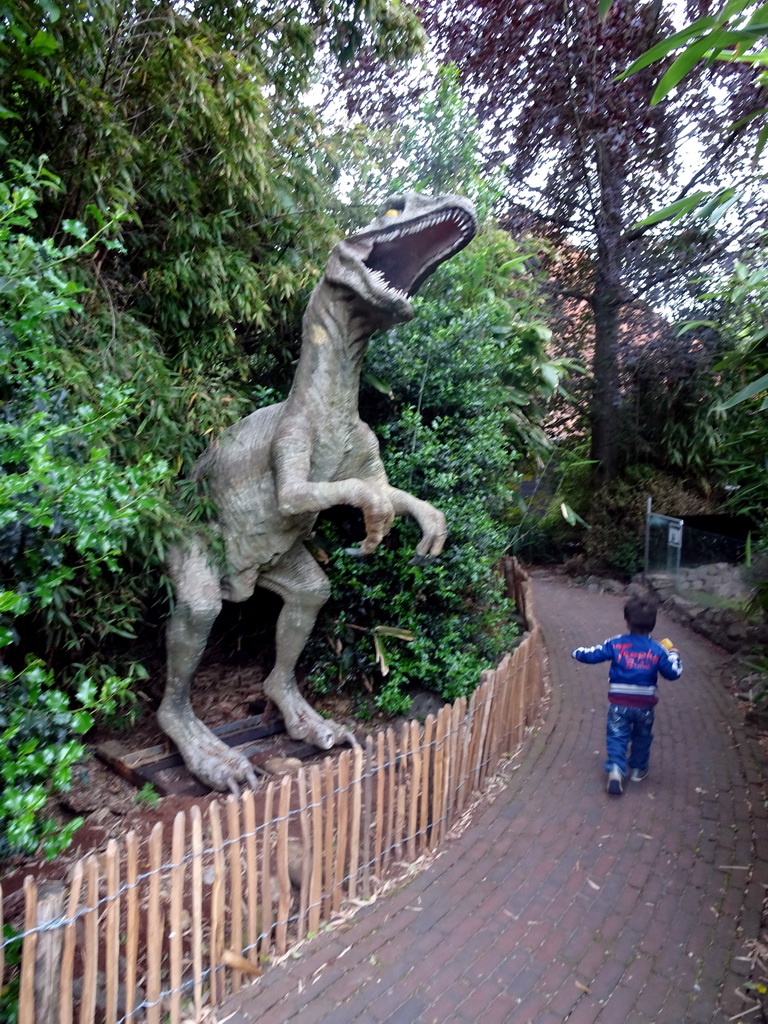 Max with a Dinosaur statue at the Dierenpark De Oliemeulen zoo