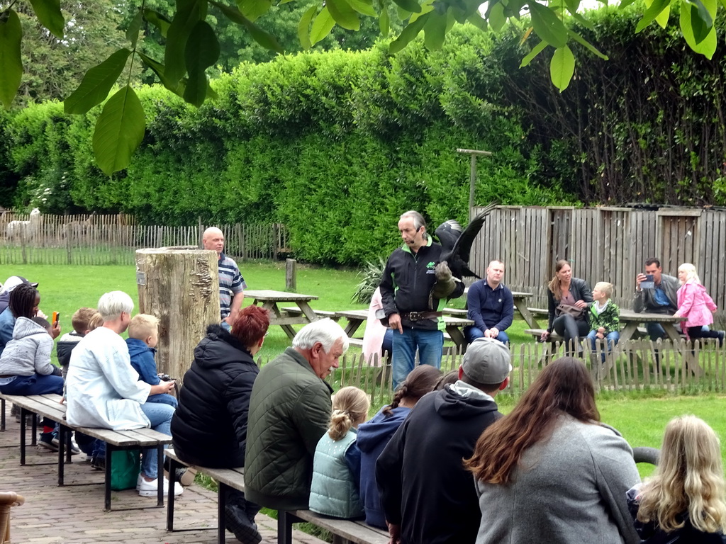 Zookeeper, bird and spectators during the Birds of Prey Show at the Dierenpark De Oliemeulen zoo