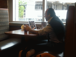 Man talking to his computer at Tim Horton`s