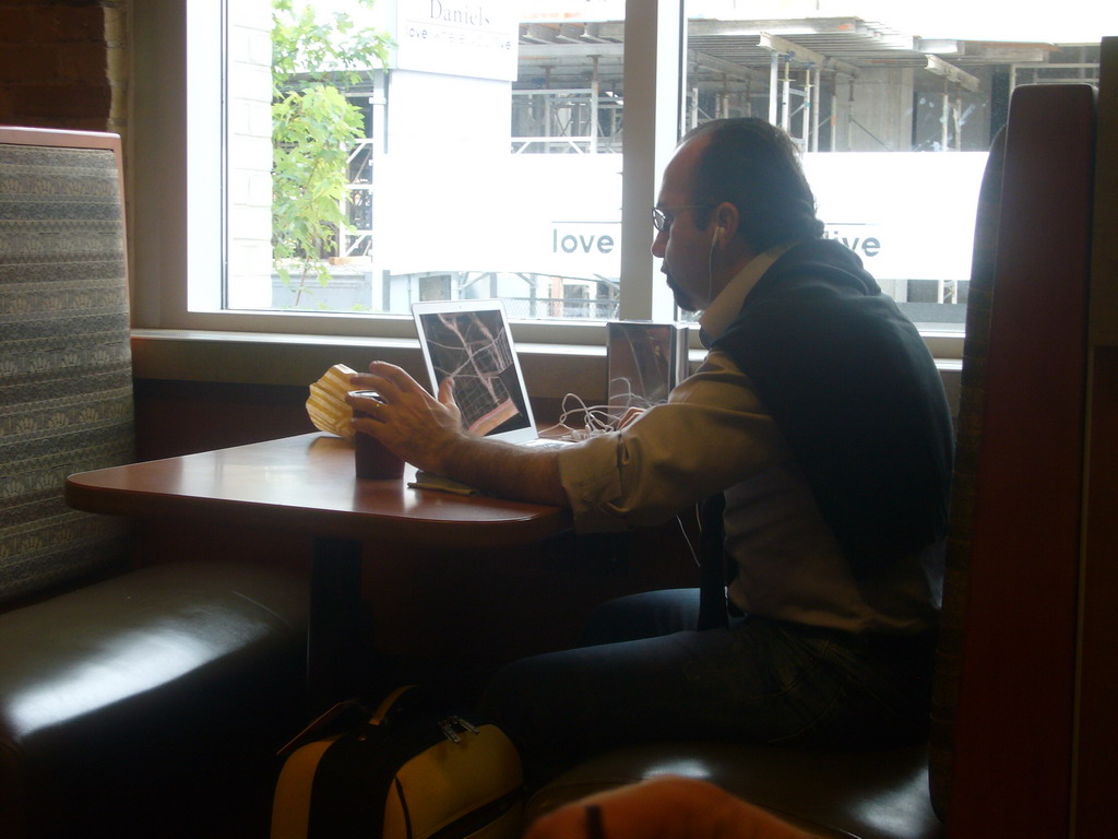 Man talking to his computer at Tim Horton`s