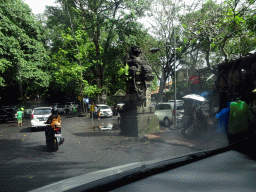 Monkey statue at the entrance to the Monkey Forest at the Jalan Monkey Forest street, viewed from the taxi