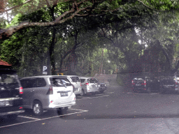 The parking place at the entrance to the Monkey Forest at the Jalan Monkey Forest street, viewed from the taxi