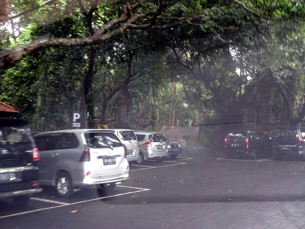 The parking place at the entrance to the Monkey Forest at the Jalan Monkey Forest street, viewed from the taxi