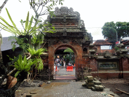 Back side of the entrance gate to the Puri Saren Agung palace, the Jalan Suweta street and the pavilion at the crossing of the Jalan Suweta street and the Jalan Raya Ubud street