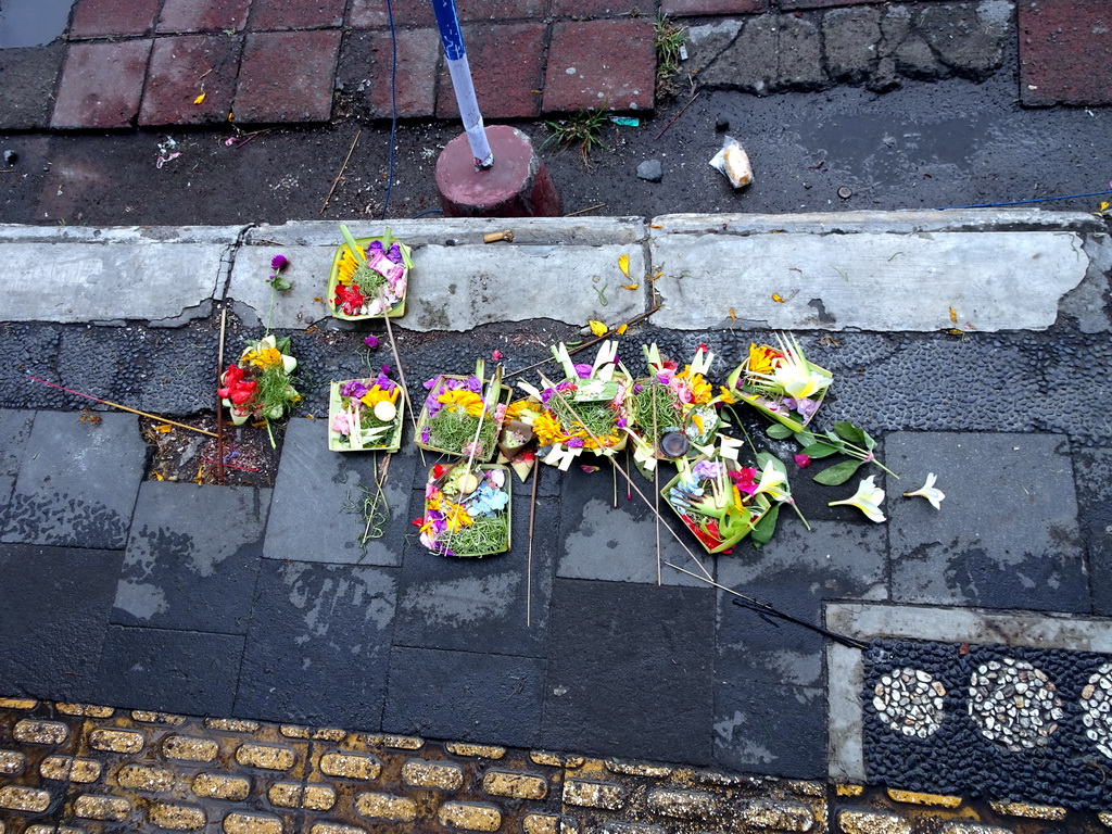 `Canang Sari` offering on the street in front of the Ubud Tourist Information Centre at the crossing of the Jalan Monkey Forest street and the Jalan Raya Ubud street