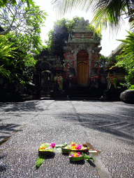 `Canang Sari` offering on the street in front of the entrance gate to a small temple at the Jalan Raya Ubud street