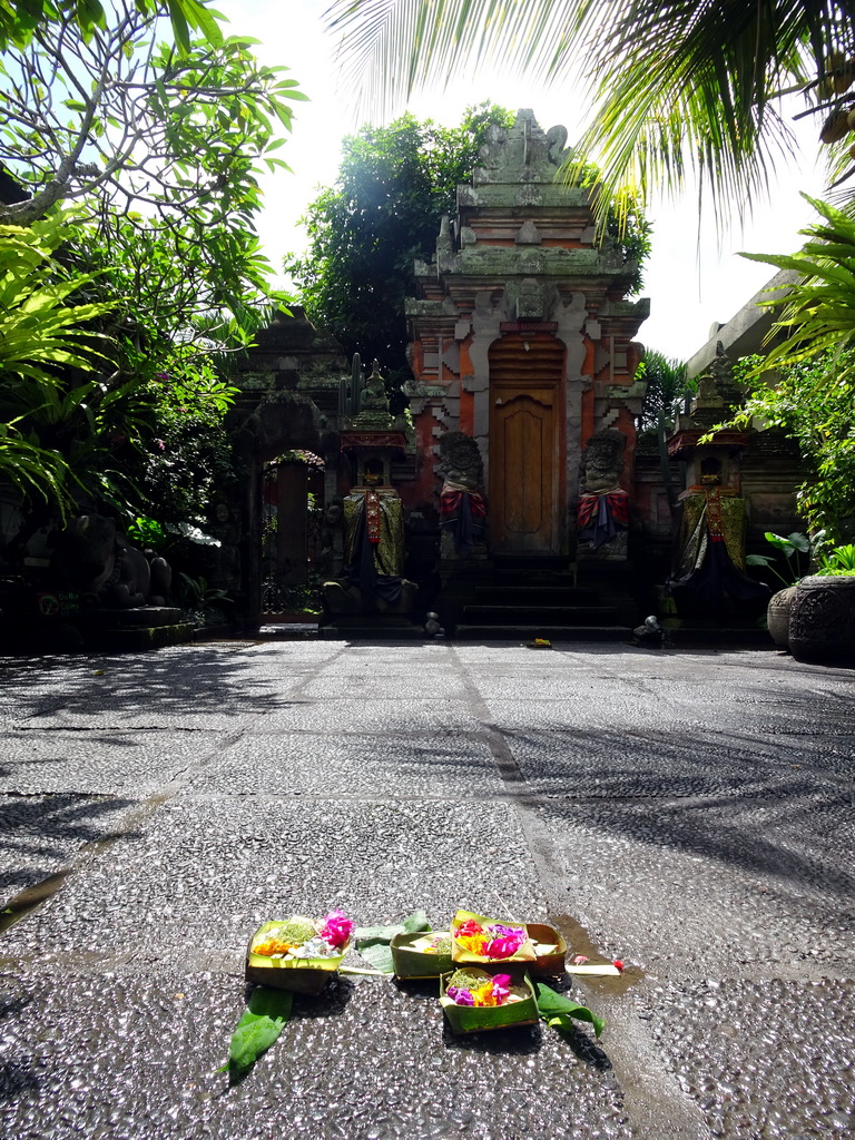 `Canang Sari` offering on the street in front of the entrance gate to a small temple at the Jalan Raya Ubud street