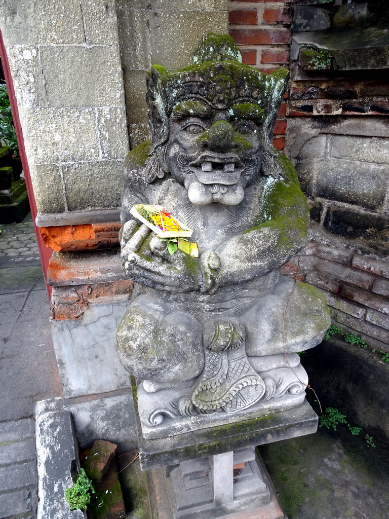 Statue in front of a small temple at the Jalan Arjuna street