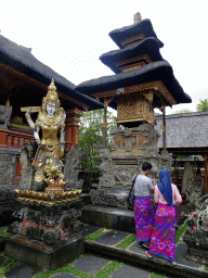 Statue and shrine at the Pura Taman Saraswati temple