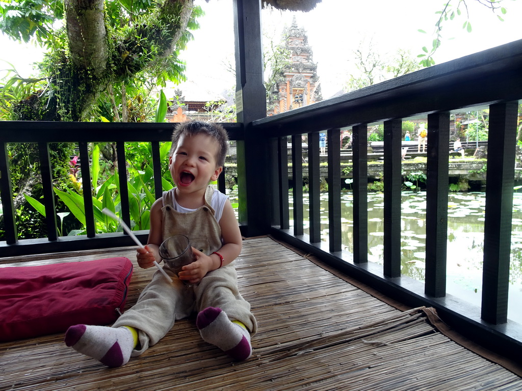 Max at the terrace of Café Lotus, with a view on the pond with lotus plants and the front of the Pura Taman Saraswati temple