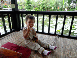 Max at the terrace of Café Lotus, with a view on the pond with lotus plants