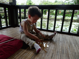 Max at the terrace of Café Lotus, with a view on the pond with lotus plants